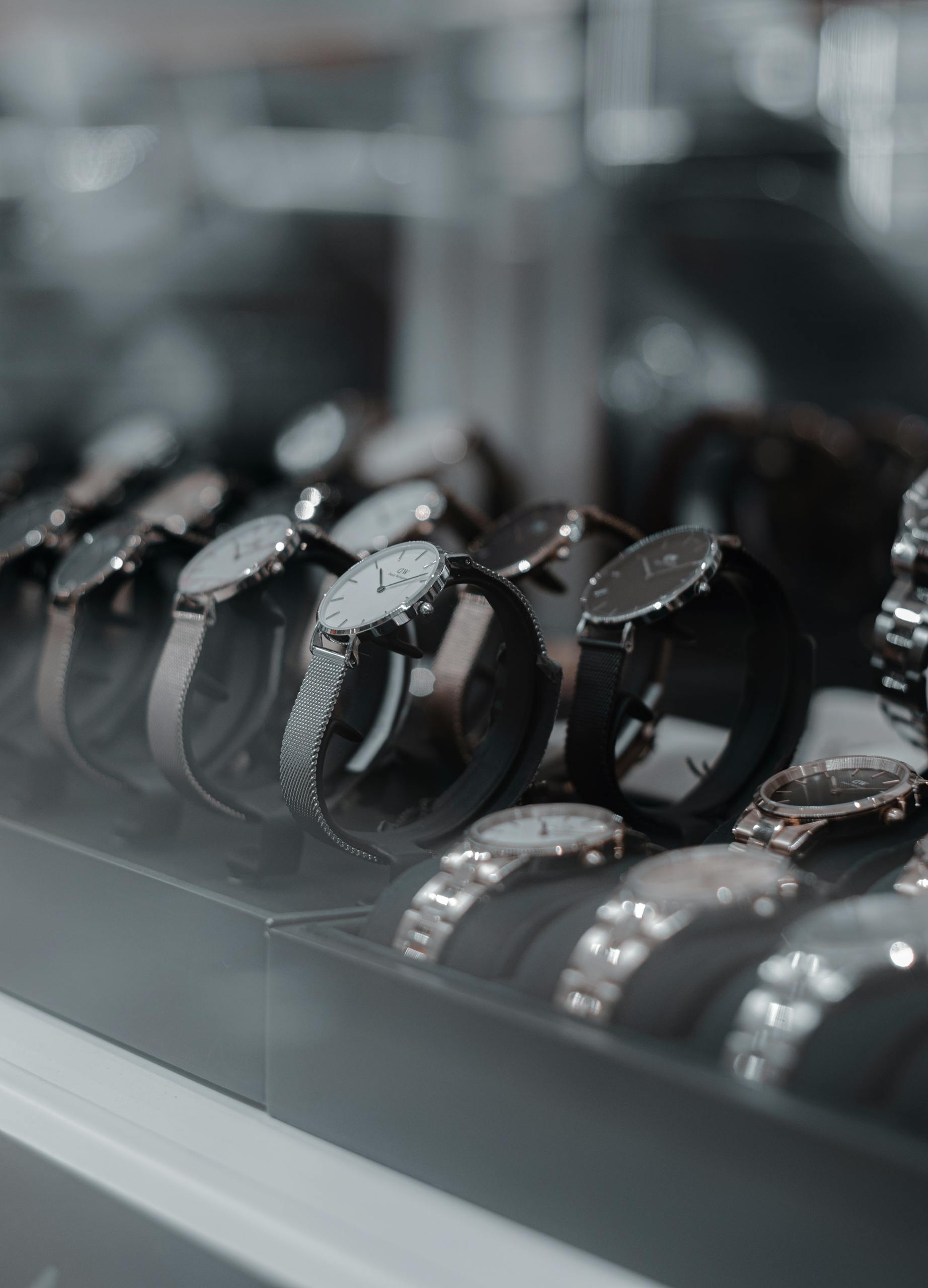 A detailed view of luxury wristwatches displayed in a store showcase, highlighting style and sophistication.